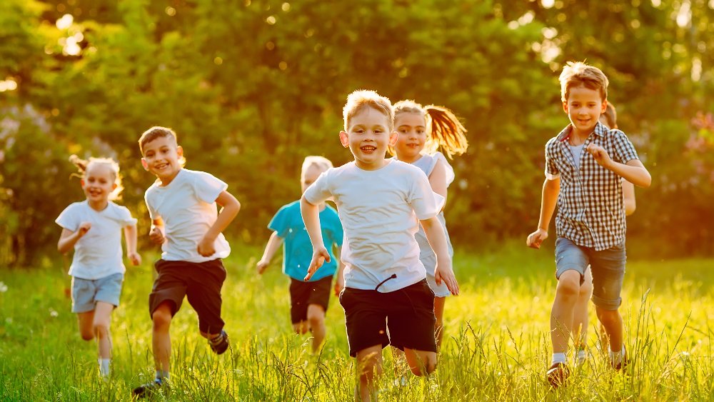 group-happy-children-boys-girls-run-park-grass-sunny-summer-day