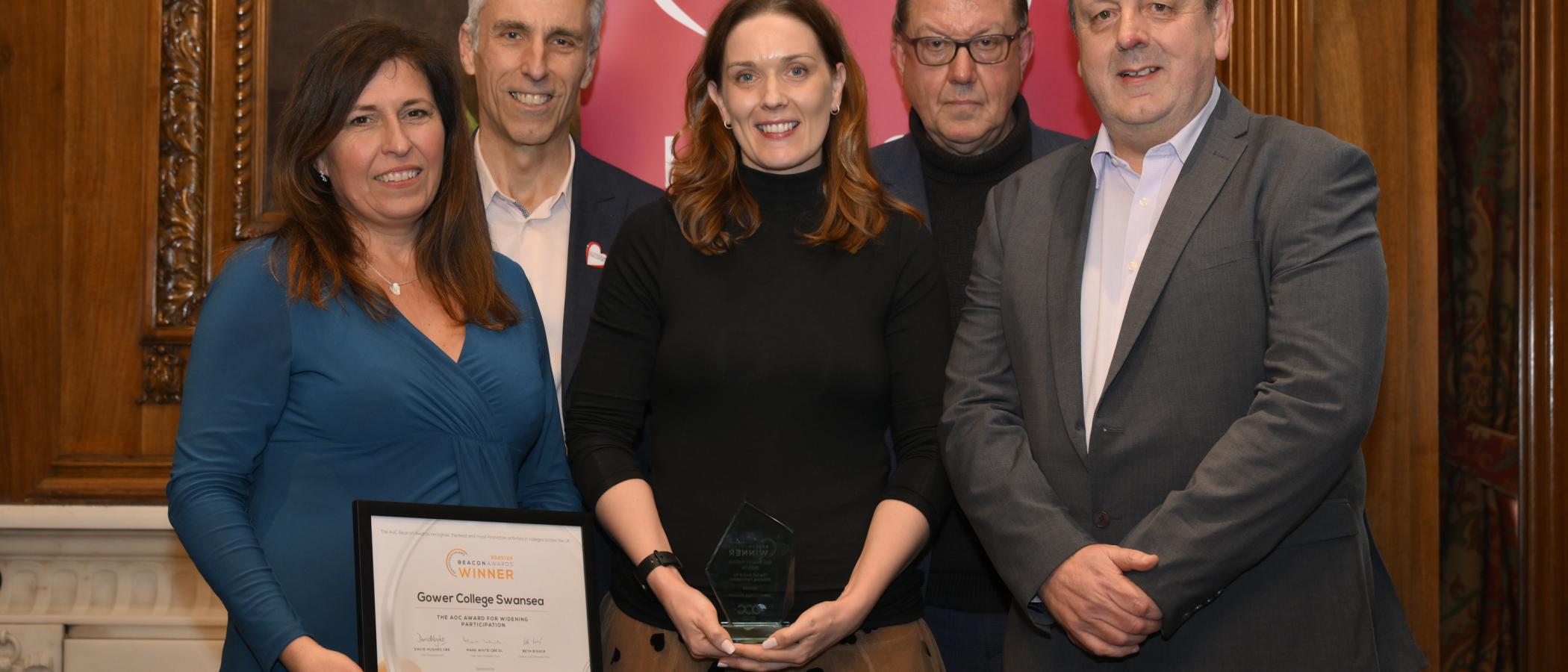 Director of Work-Based Learning Rachel Jones, Learner Support Emma Davies, and Chief Executive Officer Mark Jones are pictured with members of the Association of Colleges and the Beacon Award for Widening Participation. 