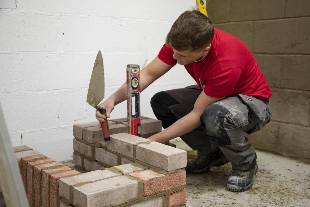 A Built Environment learner building a wall during Skills Competition Wales