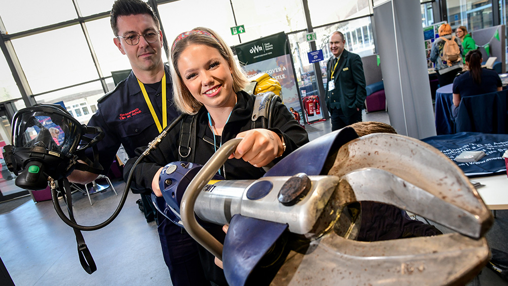 Student holding Jaws of Life at Apprenticeship Open Evening