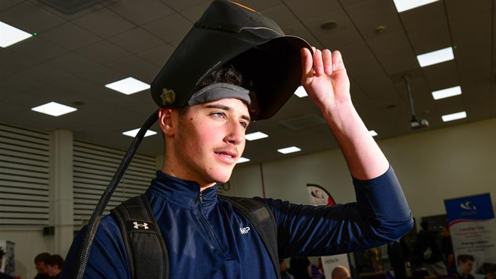 Student with welding helmet