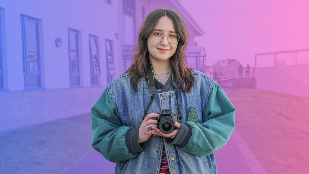 Student holding camera