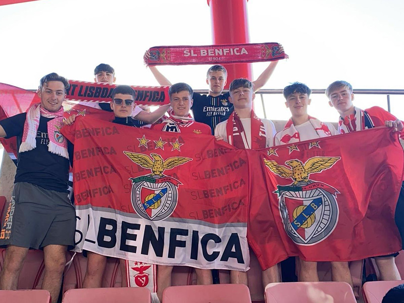 Happy students in Portugal holding SL Benfica flag