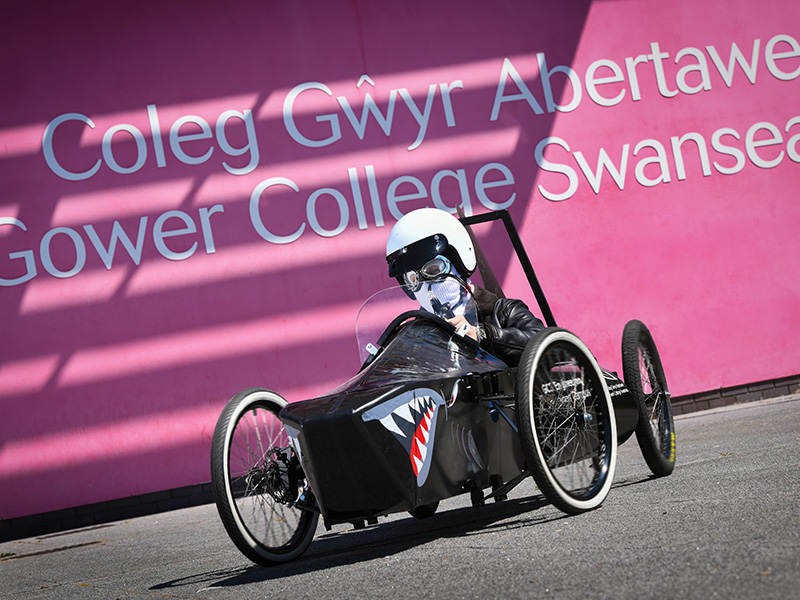 Soapbox car with driver wearing a helmet