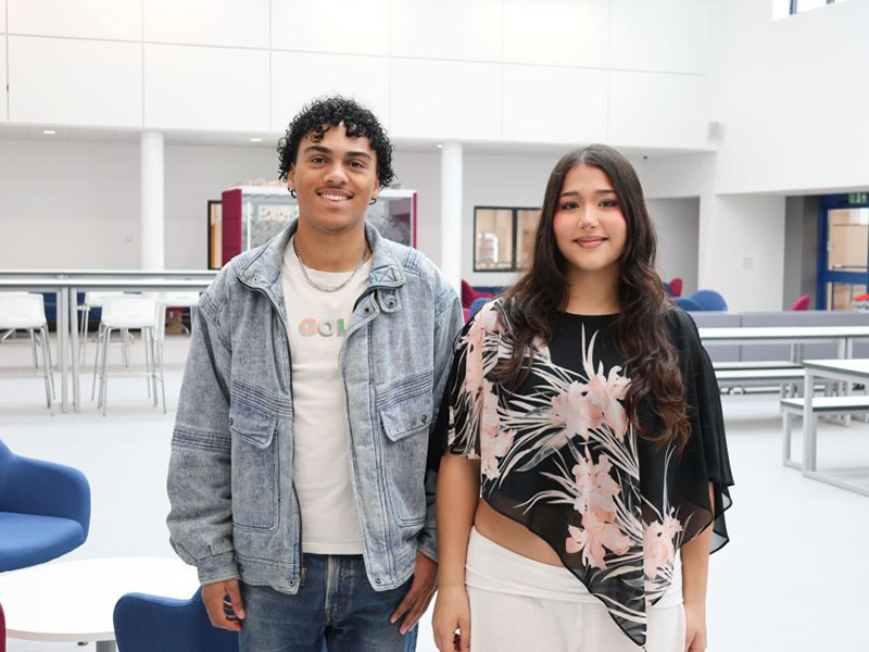 Two students stand in the new atrium space