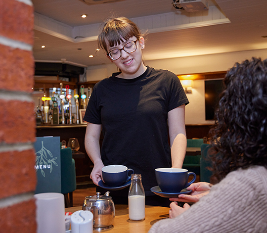 ILS student serving coffee