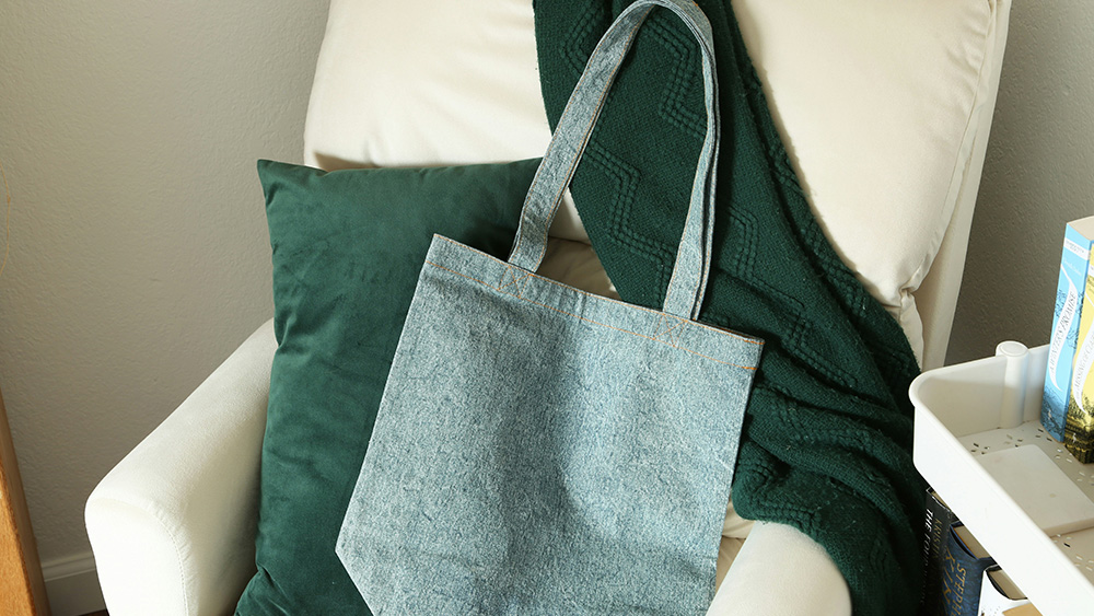 Denim tote bag displayed on chair