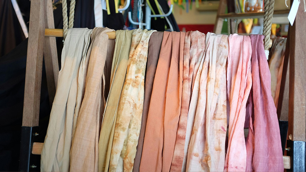 Tie dye cloths drying on rack