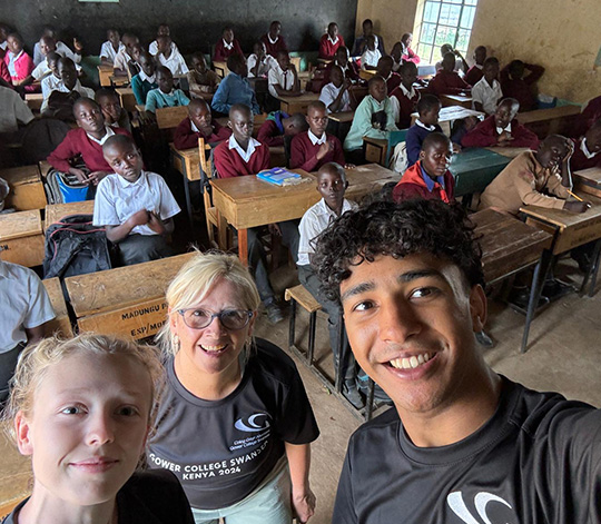 GCS Students and staff take selfie with Madungu school pupils behind at their desks
