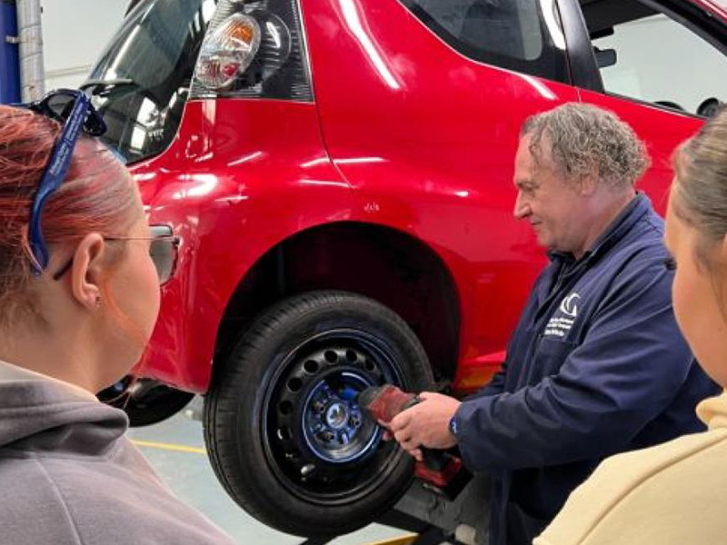 Motor Vehicle lecturer demonstrating wheel change
