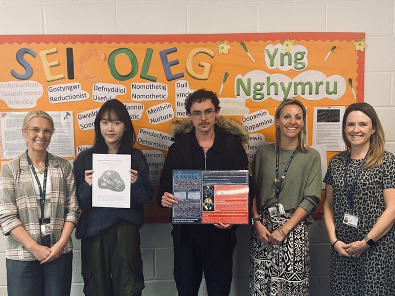 Psychology students with their winning work