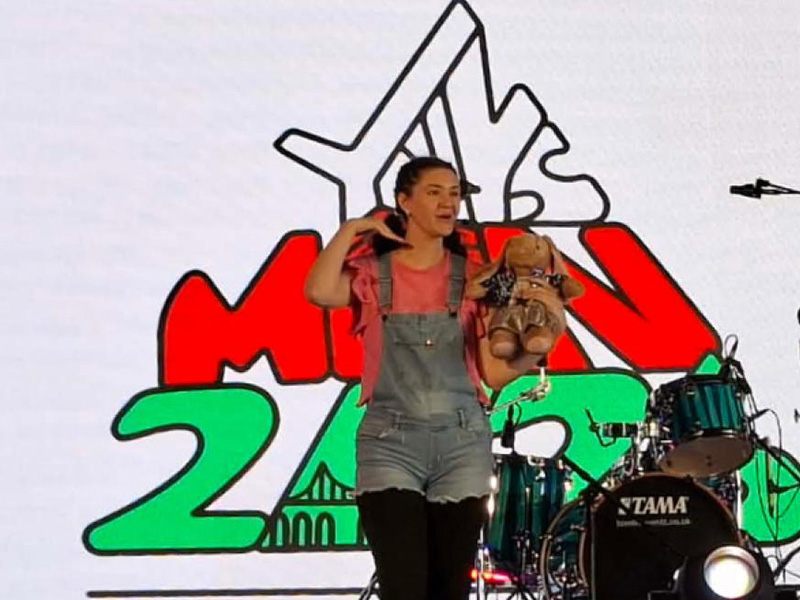 Student performing on stage at the Urdd