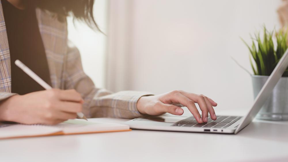 Person typing on laptop