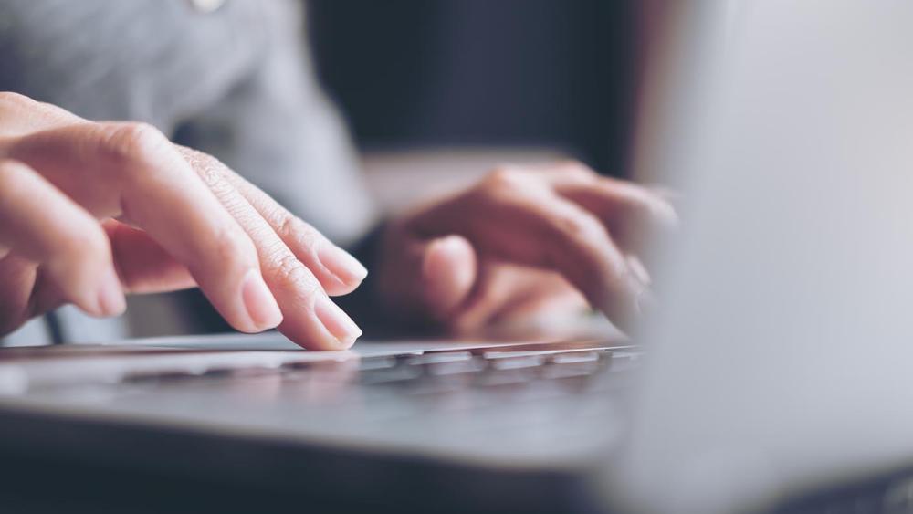 Person typing on a laptop