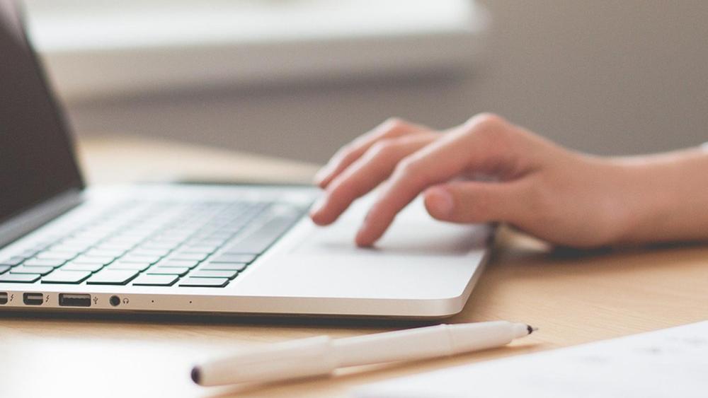 two students in lab coats in a laboratory