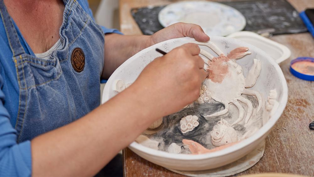 Clay pot being made by a student in a Gower College Swansea class