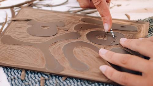 close up of person carving into lino