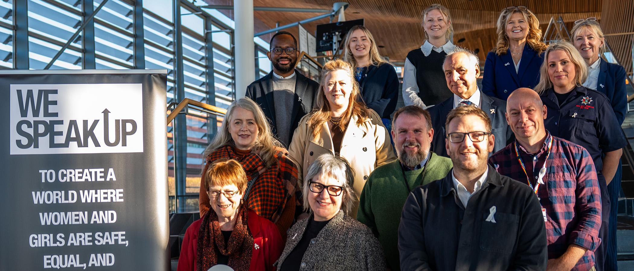 Sarah King and Lorraine Evans with group of people coming together outside the Senedd to mark White Ribbon Day