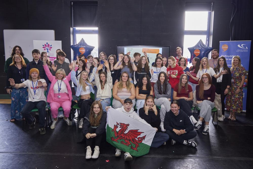 Big group shot, holding Welsh flag