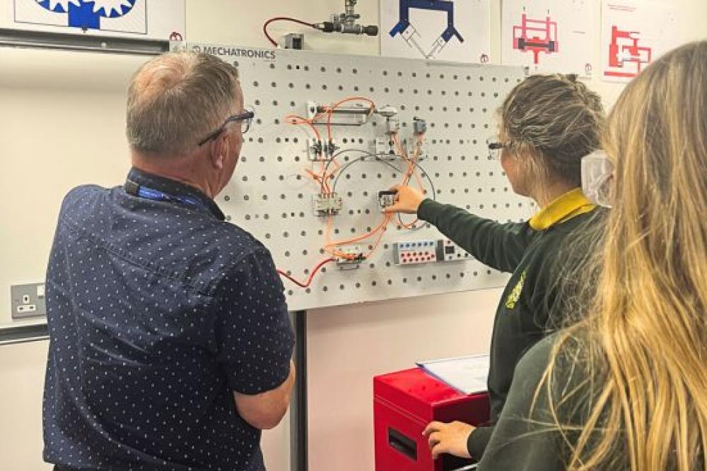 Tutor showing student wiring diagram 