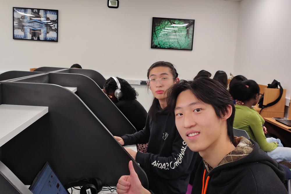 Two international students at desks